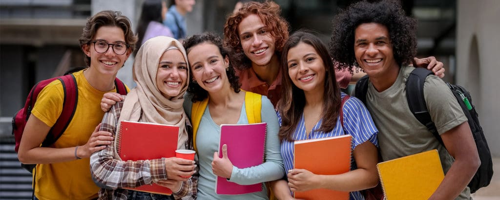 Students smiling with colorful notebooks
